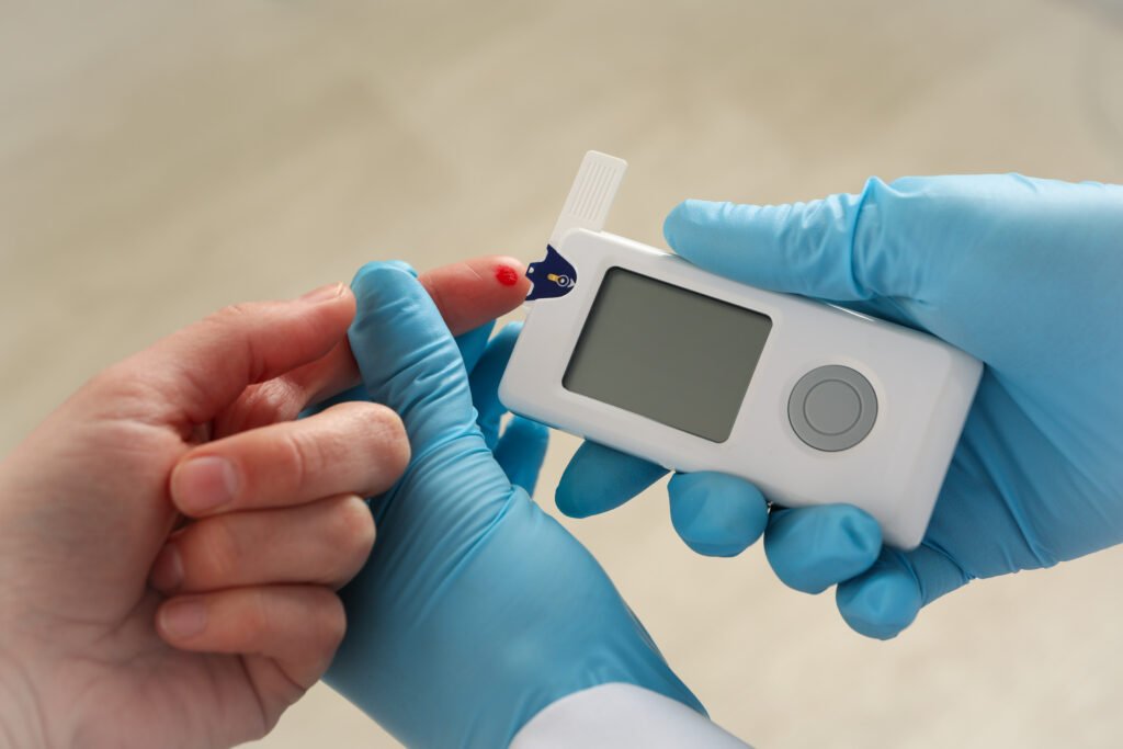 Doctor checking blood sugar level of woman, close up