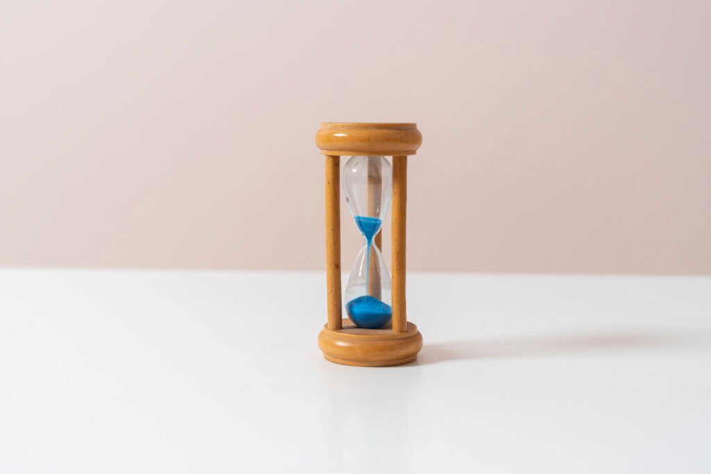 wooden antique hourglass, abstract time management concept