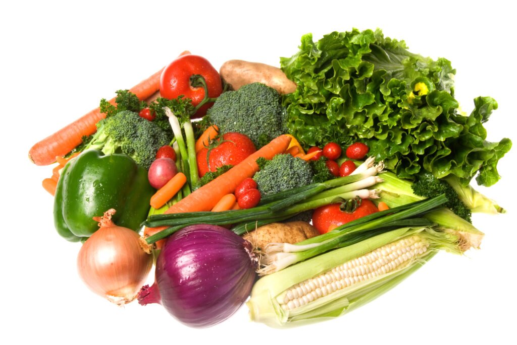 A vibrant assortment of fresh vegetables isolated on a white background.